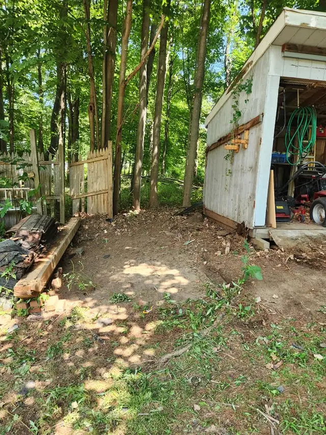 Backyard with the shed removed and the ground cleared