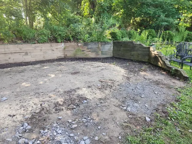 Backyard with retaining wall cleared of debris